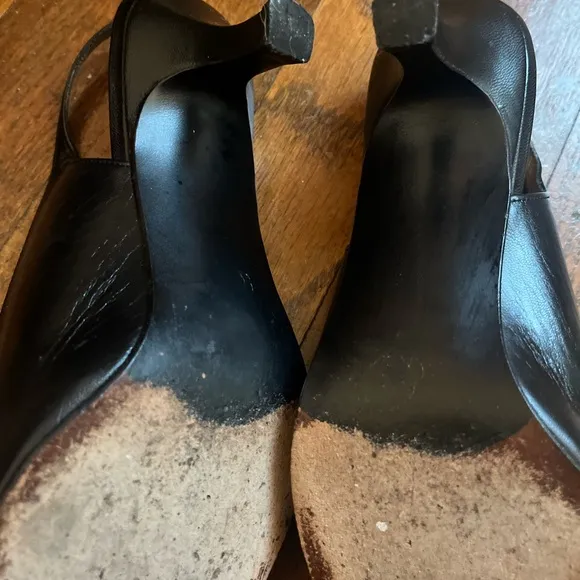 Stuart Weitzman Black and White Heels with Slingback Design and Pointed Toe .