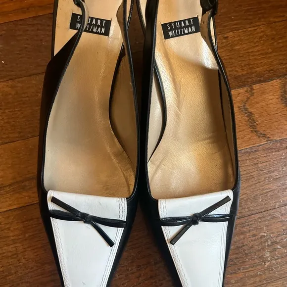 Stuart Weitzman Black and White Heels with Slingback Design and Pointed Toe .