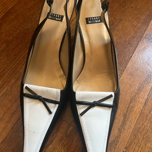Stuart Weitzman Black and White Heels with Slingback Design and Pointed Toe .