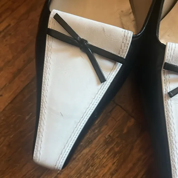 Stuart Weitzman Black and White Heels with Slingback Design and Pointed Toe .