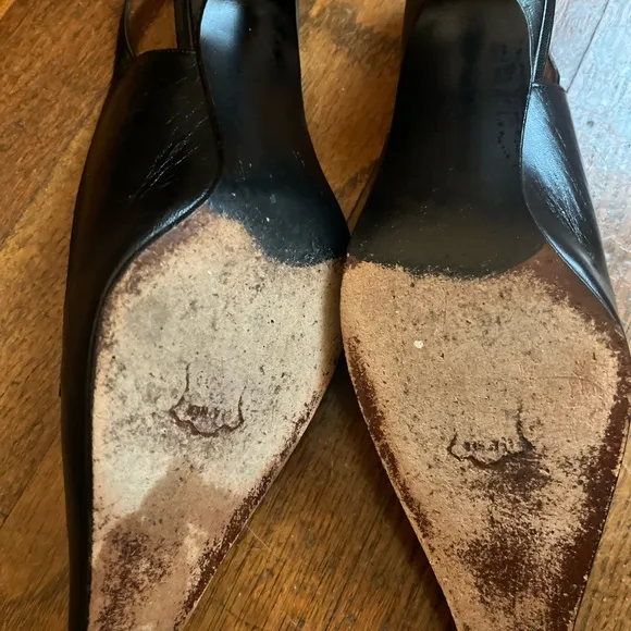 Stuart Weitzman Black and White Heels with Slingback Design and Pointed Toe .